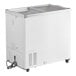 A white Galaxy flat top display freezer with the door open on wheels.