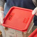 a red plastic container with a label