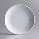 An Acopa Lunar white melamine plate with a white rim on a gray background.