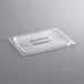 A clear plastic lid with a handle on a white surface.