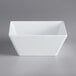 A white square bowl on a gray background.