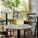 A Lancaster Table with Glasses of Beer on it and Chairs.