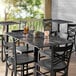 A Lancaster Table with chairs and drinks on it.