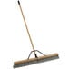 a broom with a wooden handle