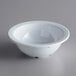 An Acopa Foundations white melamine bowl on a gray surface.