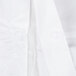 A close up of a white lab coat with buttons.