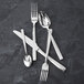 A Fortessa Catana stainless steel bouillon spoon on a table.
