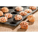 A tray of chouquettes pastries on a table.