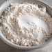 A bowl of flour on a table.