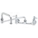 A chrome T&S wall mount pantry faucet with double-jointed swing nozzle.