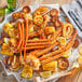 A plate of crab, corn, and vegetables with J.O. BBQ Crab Seasoning on a table.