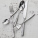 A close-up of a Fortessa Lucca stainless steel serving fork.
