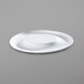 A close up of a bright white porcelain plate with a circular rim.