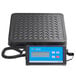 An Avaweigh digital receiving scale with a black cover and a blue and white box on a metal surface.