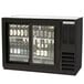 a black refrigerator with bottles of beer