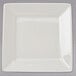 A white square Tuxton china plate with a small square cut out.