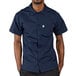 A man wearing a navy Uncommon Chef cook shirt.