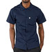A man wearing a navy Uncommon Chef cook shirt.