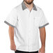 A man wearing a white Uncommon Chef cook shirt with Shepherd's check trim.