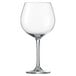 A close-up of a clear Schott Zwiesel wine glass with a stem.