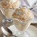 Two glass cups of Lucky Leaf rice pudding with a spoon on a plate.