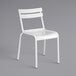 A white Lancaster Table & Seating outdoor side chair with a metal frame.