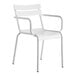A white Lancaster Table & Seating outdoor arm chair with arms.
