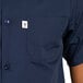 A man wearing a navy cook shirt with a white pocket.