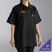 A woman wearing a black Uncommon Chef cook shirt.