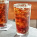 A glass of brown Boylan Root Beer with ice on a table.