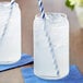 A close-up of a clear glass jar with a straw in it.