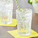 A glass of Boylan Lemon Lime soda with ice and a yellow and green striped straw.