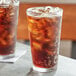 A glass of Boylan Cane Cola with ice on a table.