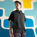 A man wearing a black Uncommon Chef cook shirt.