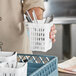 A white plastic cutlery holder designed for use with warewashing racks, shown holding utensils.