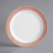 A white plastic plate with a rose gold lattice design.