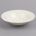 A white Homer Laughlin china monkey dish on a gray surface.