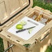 A CaterGator cooler with limes and a knife on a white surface.