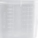 A translucent plastic food pan with measurements on it.