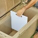 A person using a white CaterGator divider to open a cooler.