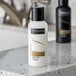 A white TRESemme Luxurious Moisture Conditioner bottle on a counter.