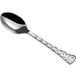 a silver spoon with a textured handle