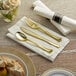 A pre-rolled napkin with a fork and knife on a table.