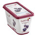 A container of Les Vergers Boiron frozen blueberry puree next to a bowl of blueberry yogurt.