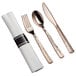 A Visions Hammersmith rose gold plastic cutlery set with a fork and spoon wrapped in a white napkin.