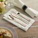 Hammersmith rose gold plastic cutlery on a napkin with a Visions linen-feel napkin.