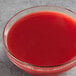 A glass bowl of Les Vergers Boiron Blood Orange fruit puree on a counter.