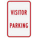 A white sign with red text that says "Visitor Parking" and features a red border.