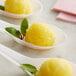 Three spoons filled with Les Vergers Boiron pineapple fruit puree with yellow ice cream.