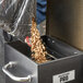 A person pouring wood pellets into a Backyard Pro wood pellet grill.